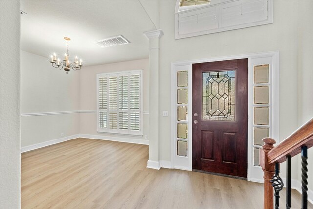 entrance foyer with a notable chandelier and light wood-type flooring