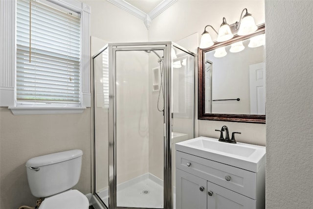 full bath featuring a shower stall, vanity, crown molding, and toilet