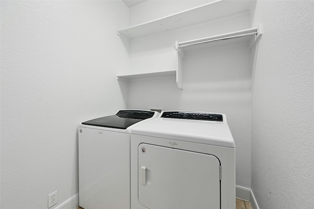 clothes washing area with washer and clothes dryer