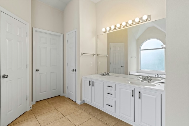 bathroom featuring a sink, double vanity, and tile patterned flooring