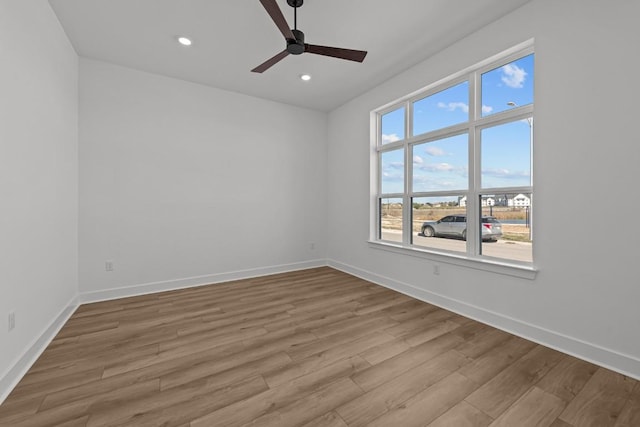 empty room featuring recessed lighting, baseboards, wood finished floors, and ceiling fan