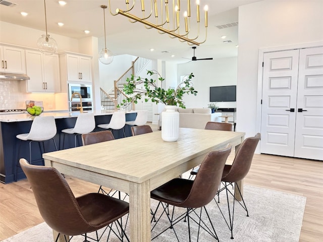 dining space with stairway, recessed lighting, visible vents, and light wood-type flooring