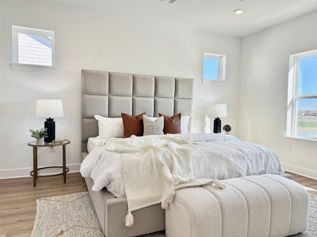 bedroom featuring baseboards and wood finished floors