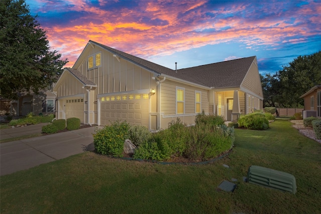 view of front of house featuring a garage and a lawn