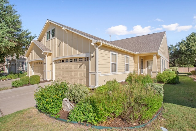 view of front of house with a front yard and a garage