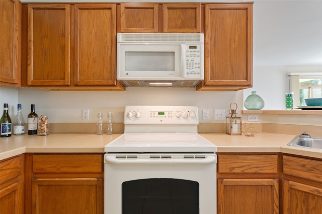 kitchen with sink and white appliances