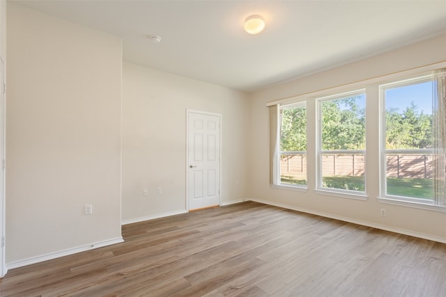 empty room with hardwood / wood-style flooring