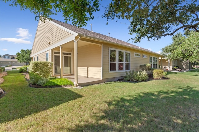 rear view of house featuring a lawn