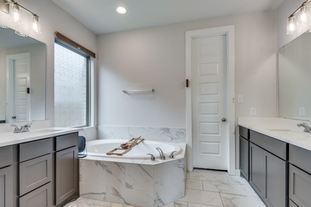 bathroom with vanity and tiled bath