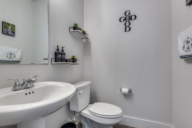 bathroom featuring sink and toilet