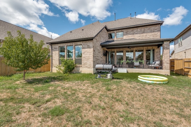 back of property featuring a patio, a yard, an outdoor living space, and ceiling fan