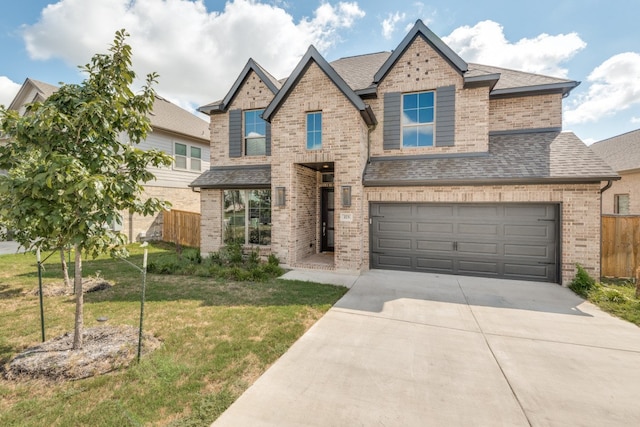 craftsman inspired home featuring a garage and a front yard