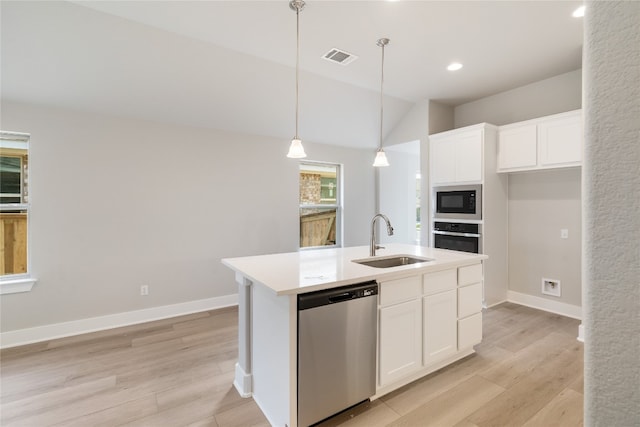 kitchen featuring appliances with stainless steel finishes, light hardwood / wood-style floors, sink, a kitchen island with sink, and white cabinets