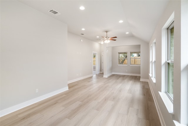 unfurnished living room with light hardwood / wood-style floors, vaulted ceiling, and ceiling fan