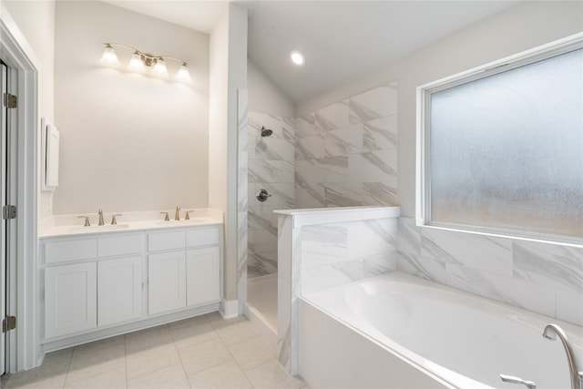 bathroom with tile patterned floors, double vanity, and a tile shower