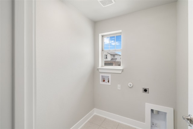 laundry room featuring gas dryer hookup, light tile patterned flooring, electric dryer hookup, and hookup for a washing machine