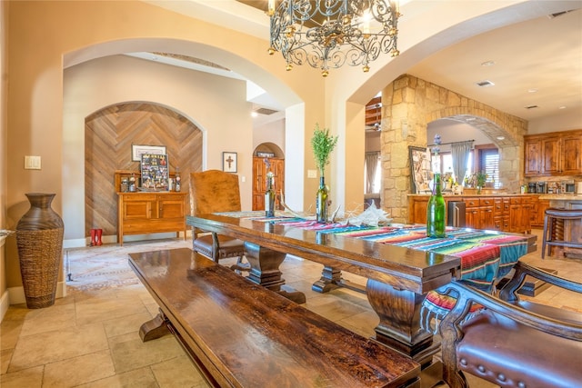 tiled dining room featuring an inviting chandelier