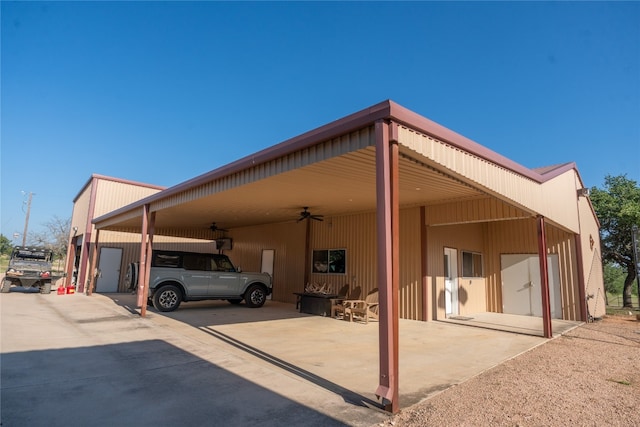 view of vehicle parking featuring ceiling fan and a carport