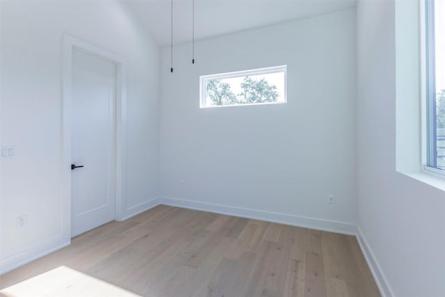 empty room with light wood-style flooring and baseboards