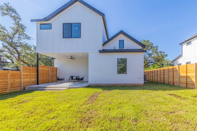 back of house with ceiling fan, a patio area, and a yard