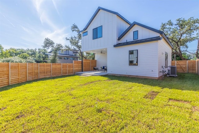 back of property featuring a fenced backyard, central air condition unit, a lawn, board and batten siding, and a patio area