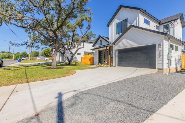 view of property exterior with board and batten siding, concrete driveway, a lawn, and a garage