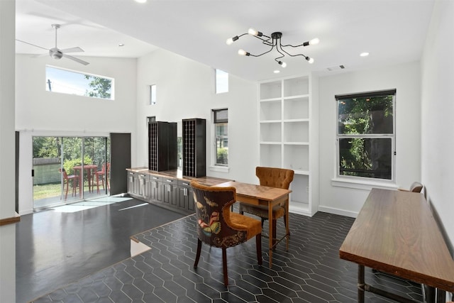 dining room featuring recessed lighting, baseboards, visible vents, a high ceiling, and ceiling fan with notable chandelier