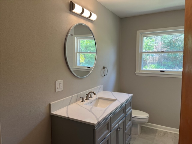 bathroom with tile patterned flooring, toilet, and vanity