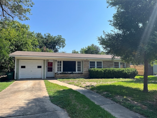 single story home featuring a garage and a front yard