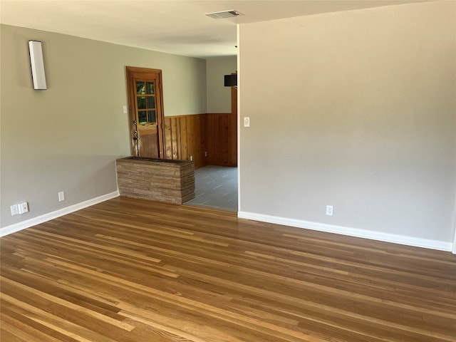 empty room with dark hardwood / wood-style floors