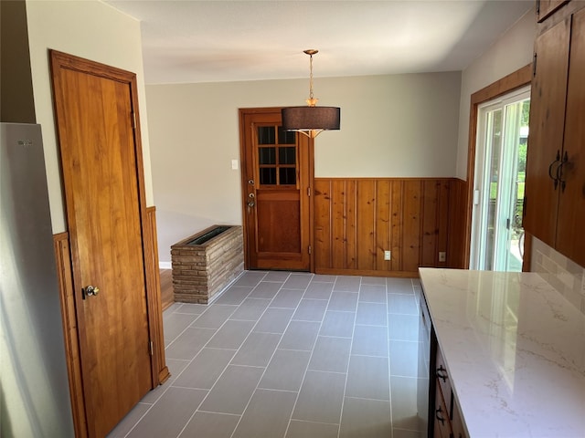 unfurnished dining area with tile patterned floors