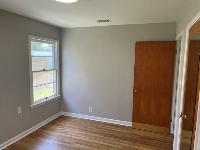 empty room featuring wood-type flooring