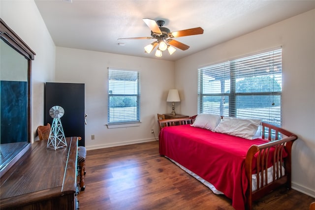 bedroom with ceiling fan and dark hardwood / wood-style floors