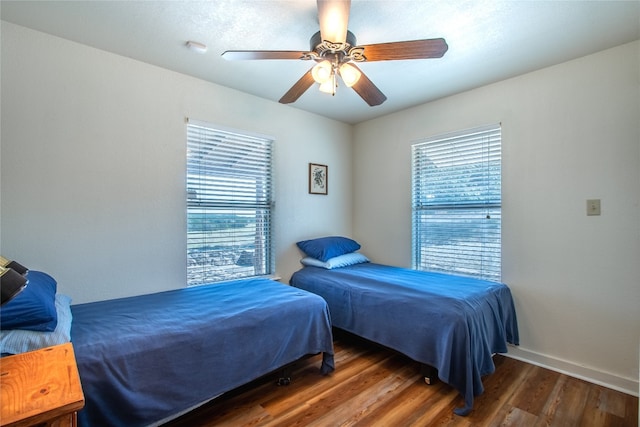 bedroom featuring ceiling fan and dark wood-type flooring