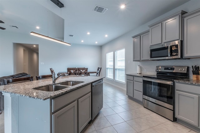 kitchen with appliances with stainless steel finishes, gray cabinets, and sink