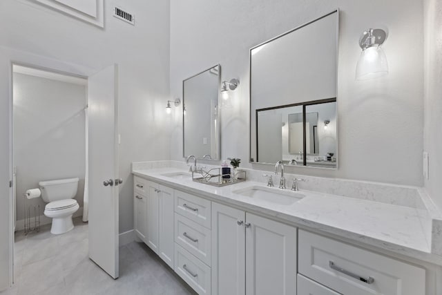 bathroom with tile patterned floors, vanity, and toilet