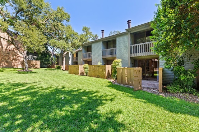 view of property's community with a lawn