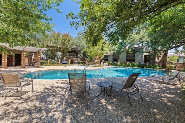 view of swimming pool featuring a patio area