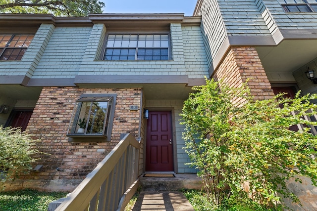 doorway to property with brick siding