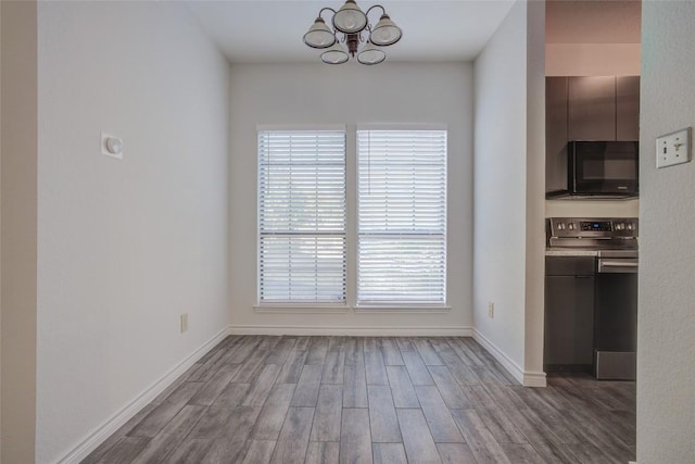 3001 Cedar St Unit A-116, Austin, TX 78705 - unfurnished dining area with a chandelier and wood finished floors