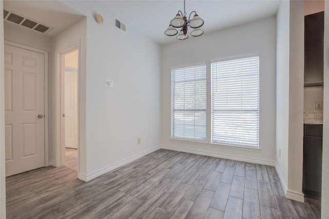 3001 Cedar St Unit A-116, Austin, TX 78705 - unfurnished dining area with wood finished floors, a chandelier, and plenty of natural light