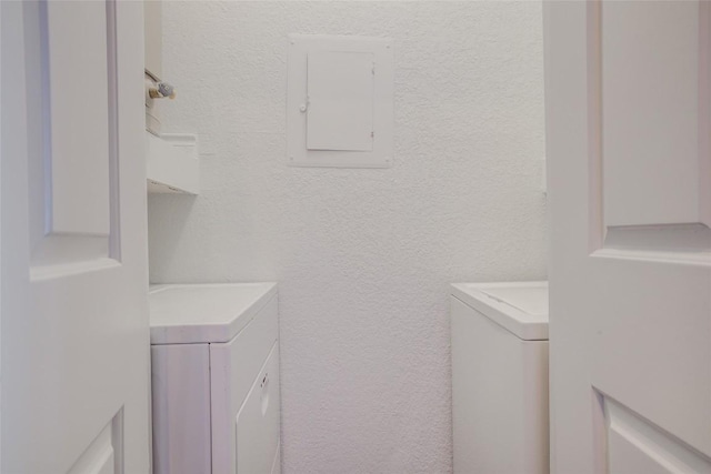 3001 Cedar St Unit A-116, Austin, TX 78705 - laundry room featuring washer / dryer, electric panel, and a textured wall