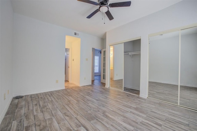 3001 Cedar St Unit A-116, Austin, TX 78705 - unfurnished bedroom with wood finished floors, multiple closets, and ceiling fan