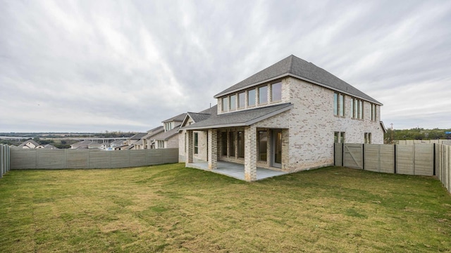 rear view of property featuring a patio and a yard