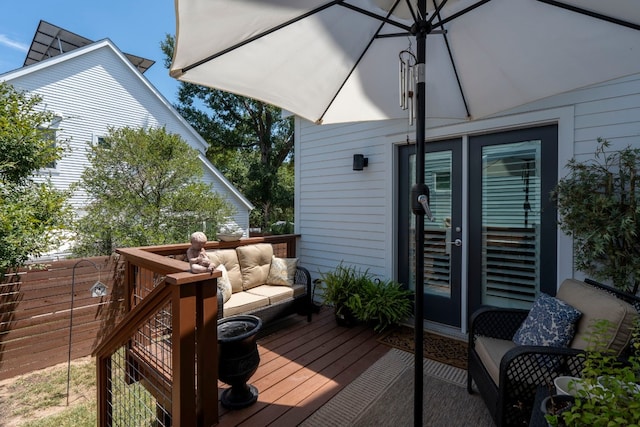 wooden terrace with french doors and an outdoor hangout area