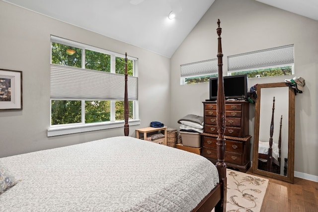 bedroom with light wood-type flooring, vaulted ceiling, and ceiling fan