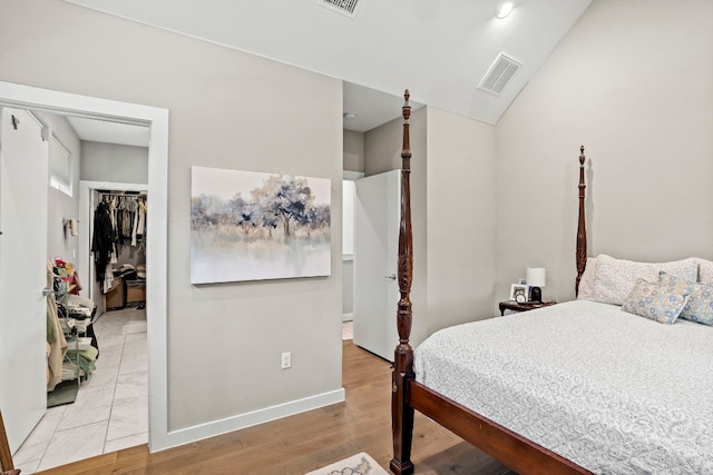 bedroom with a closet and light hardwood / wood-style floors