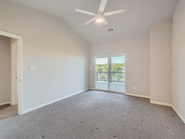 empty room with ceiling fan, carpet floors, and vaulted ceiling