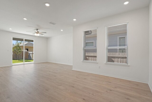 unfurnished room with light wood-type flooring and ceiling fan