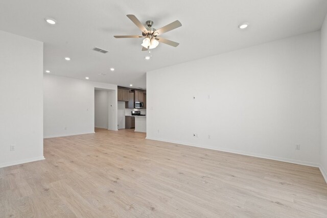 unfurnished living room featuring light hardwood / wood-style floors and ceiling fan